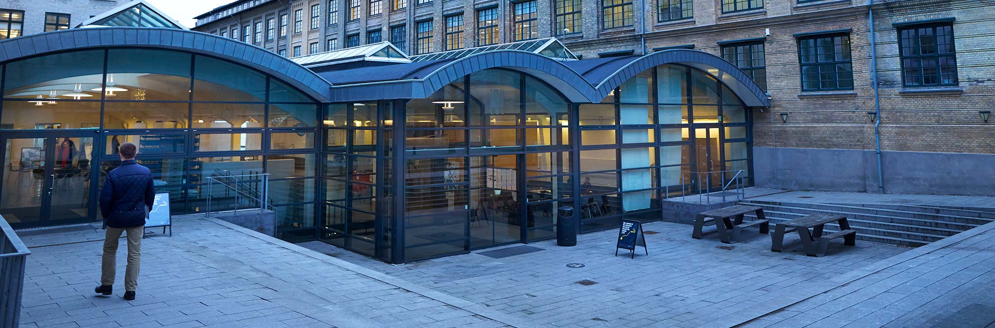 Porcelænshaven outside with a person walking towards the entrance